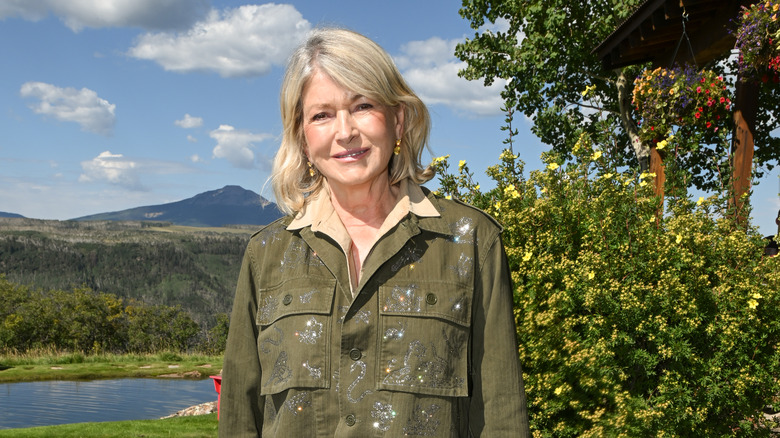 Martha Stewart in front of a stream and mountains