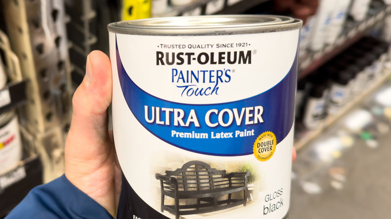 hand holding can of Rust-oleum latex paint