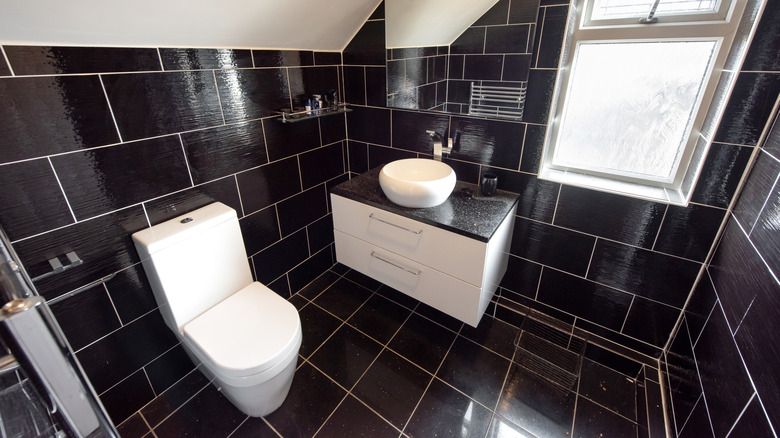 small bathroom with black tiles