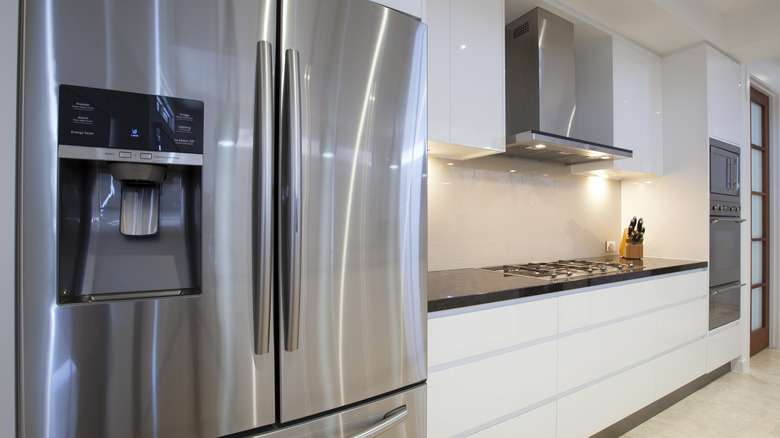 Modern kitchen with stainless steel refrigerator