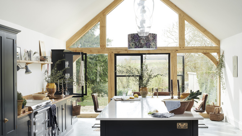 Kitchen by deVOL Kitchens with large glass wall