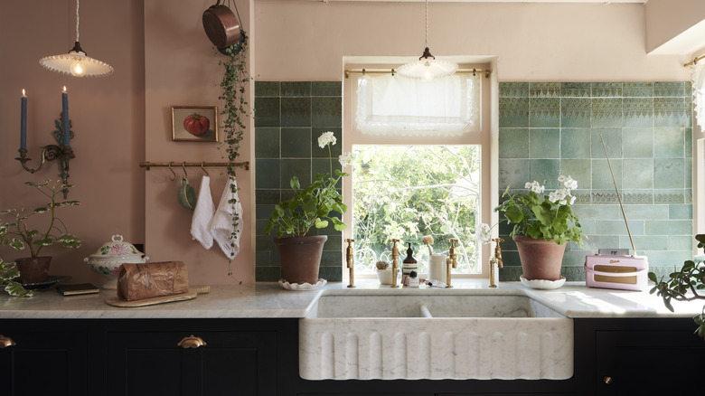 Kitchen by deVOL Kitchens with marble sink and green backsplash