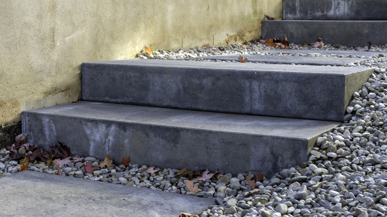 Precast concrete stairs leading up a gravel hill