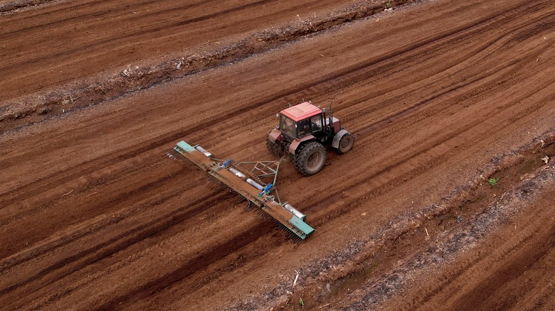 a tractor harvesting peat moss