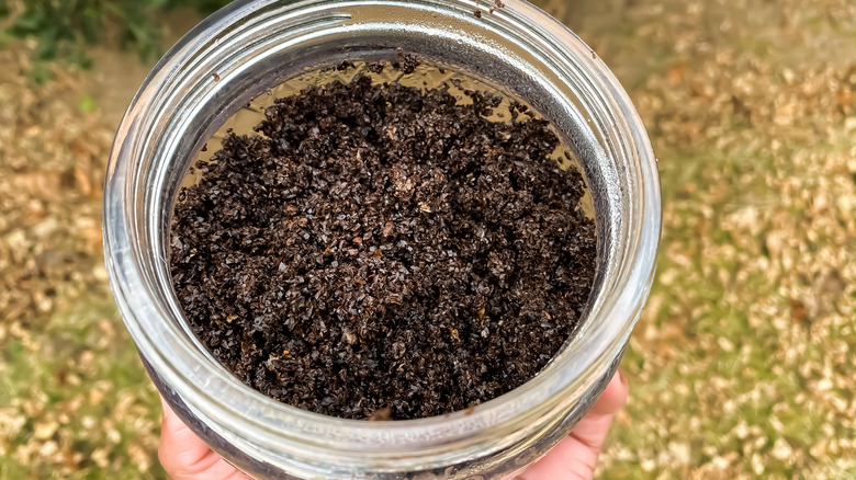 Jar with used coffee grounds