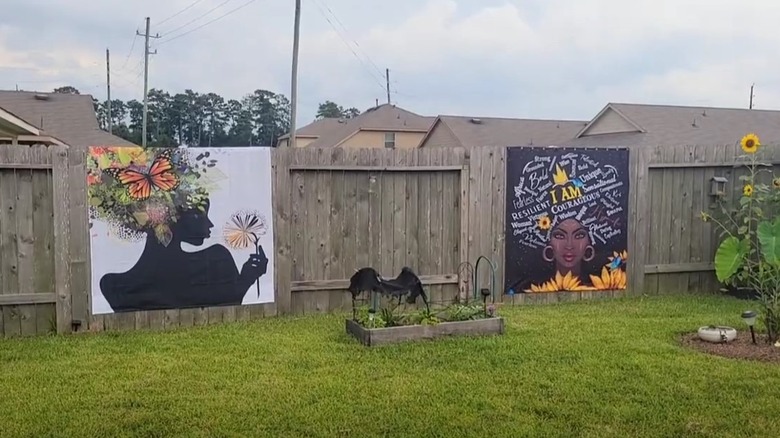 Shower curtains used as fence art