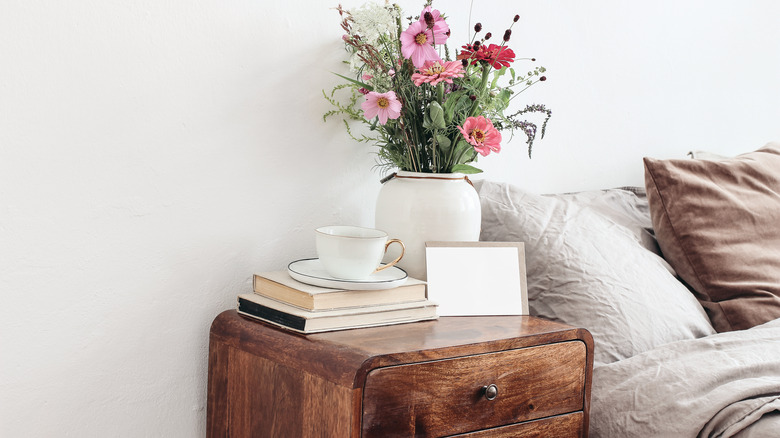 flower vase on wooden nightstand