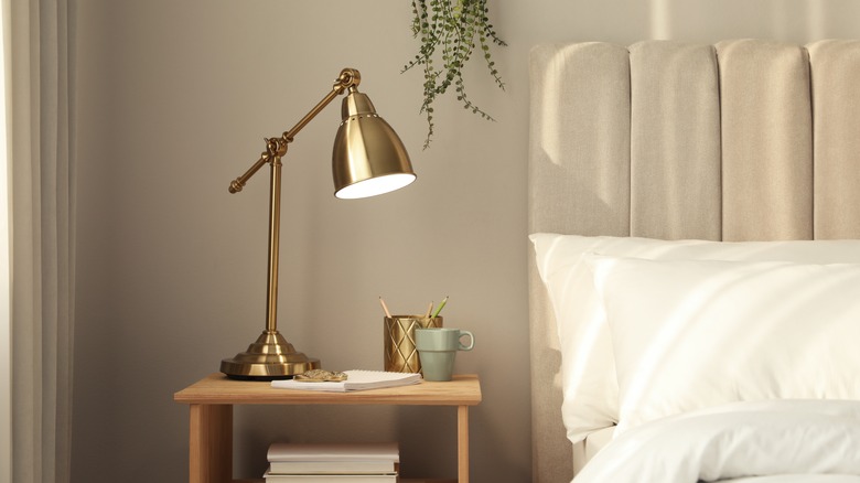 tall gold lamp on nightstand