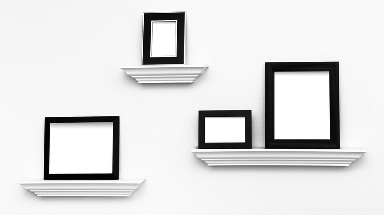 four picture frames on ledges