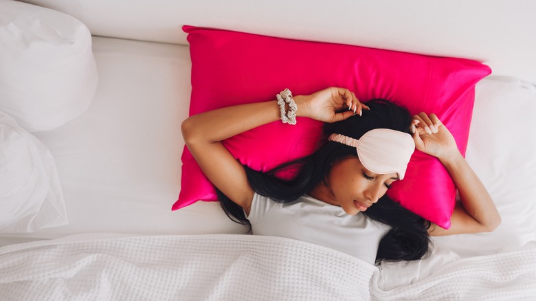 Woman sleeping on red pillow