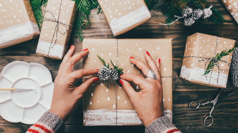 Tying pine cones to a gift