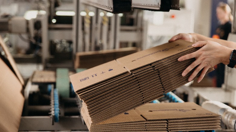 Hands holding corrugated cardboard