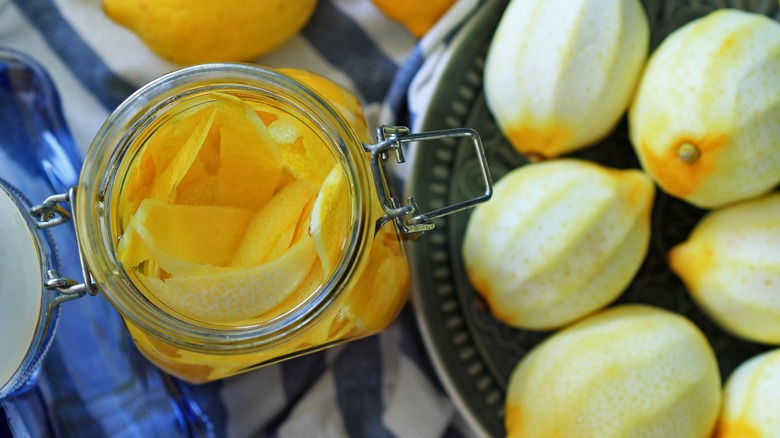 peeled lemons and jar of peels