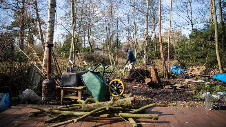 A man in the middle of a backyard renovation.