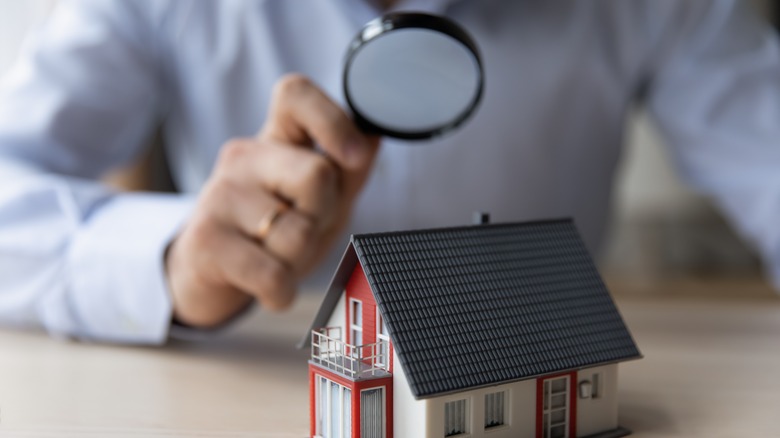 Man with miniature house model