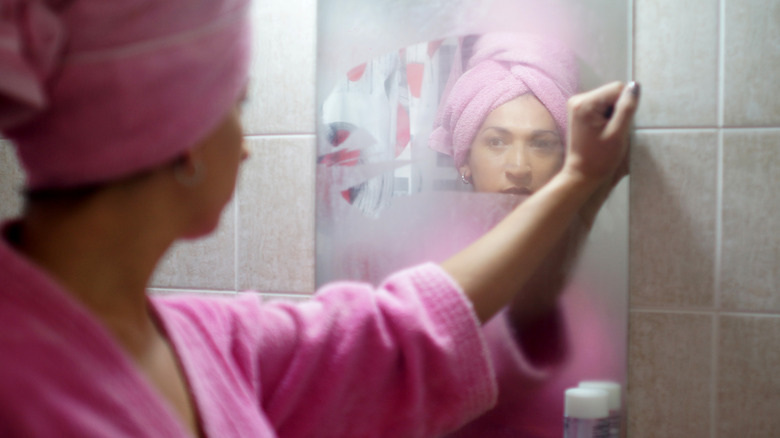 Woman in steamy bathroom