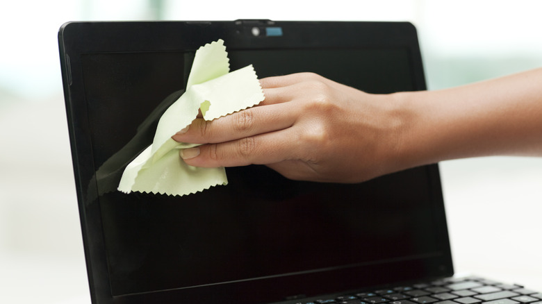 Cleaning laptop screen with microfiber cloth