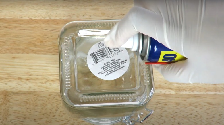 spraying sticker with WD-40