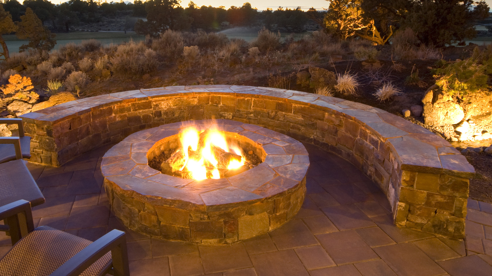 https://www.housedigest.com/img/gallery/placing-a-firepit-on-your-patio-paver-backyard-could-be-a-mistake-heres-why/l-intro-1684158033.jpg