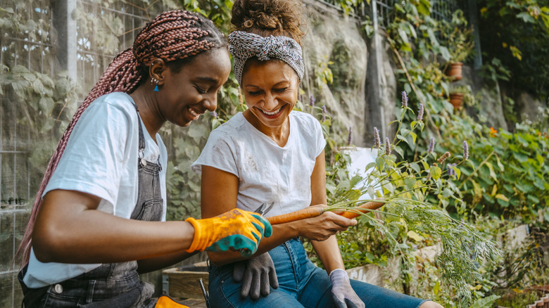 Two women who are tending to their garden