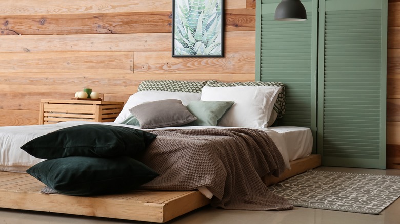 bed in front of wood wall