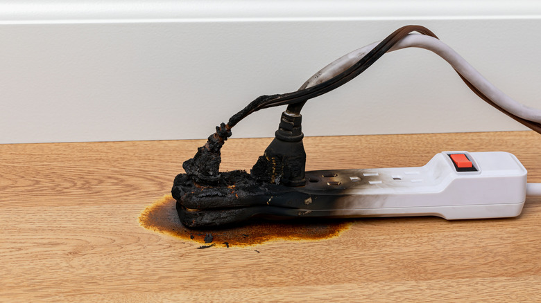 An extension cord is melted with a surge protector or power strip