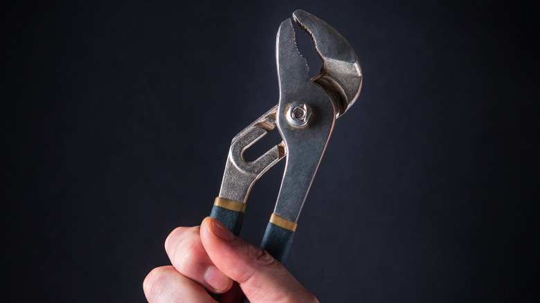 hand holding channel type pliers