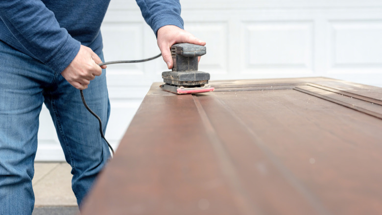 Homeowner refinishing doors