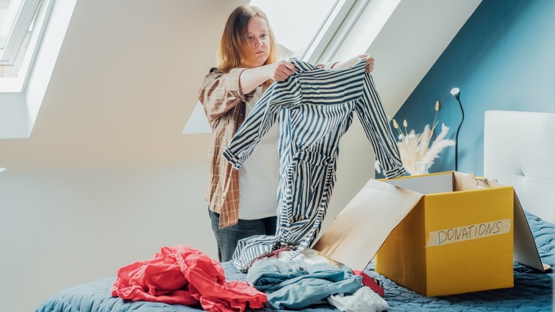 woman decluttering clothes in home