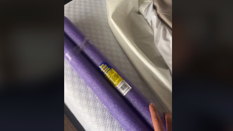 pool noodle bumper on the edge of a bed