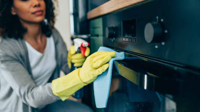 Woman cleaning oven