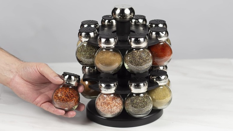 Unique rotating prelabeled and prefilled spice jars on countertop