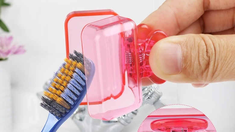 fingers clipping pink toothbrush cover