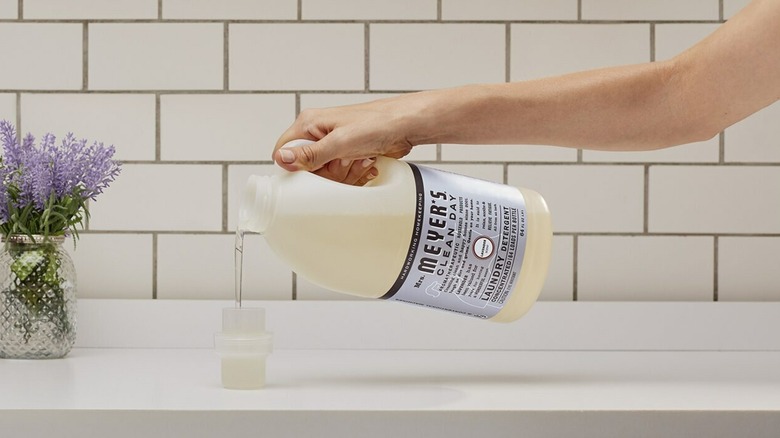 A person pouring Mrs. Meyers Clean Day detergent