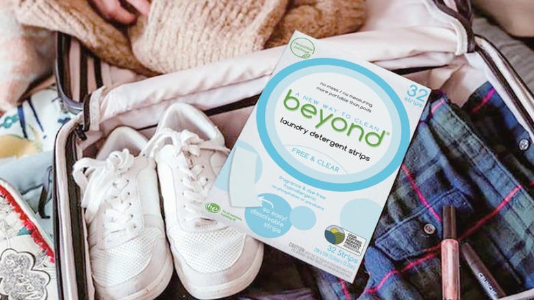 Package of Beyond Laundry Detergent Strips in full, open suitcase