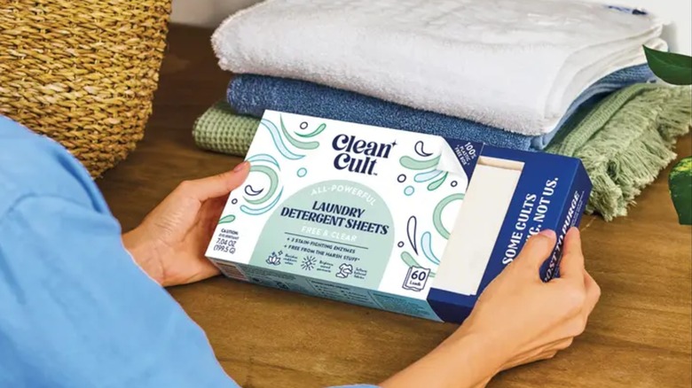 Person holding box of Cleancult Laundry Detergent Sheets