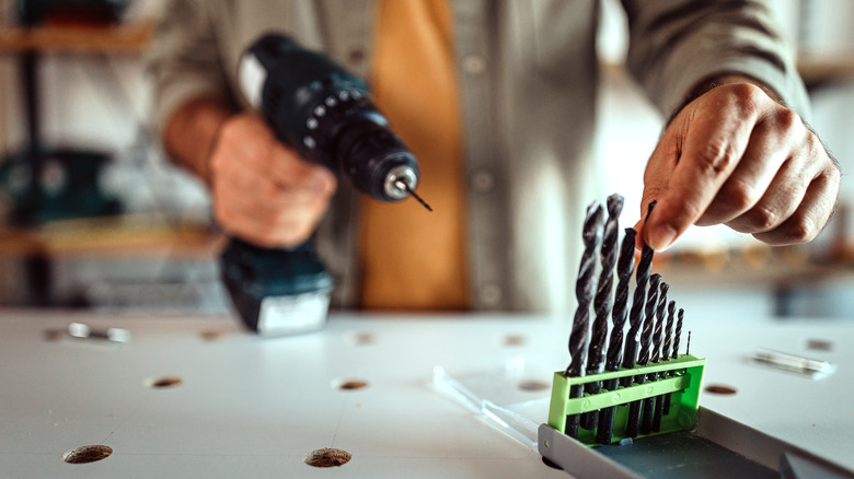 Person selecting a drill bit 