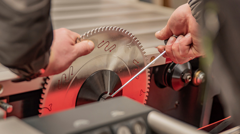 Person installing a circular saw blade