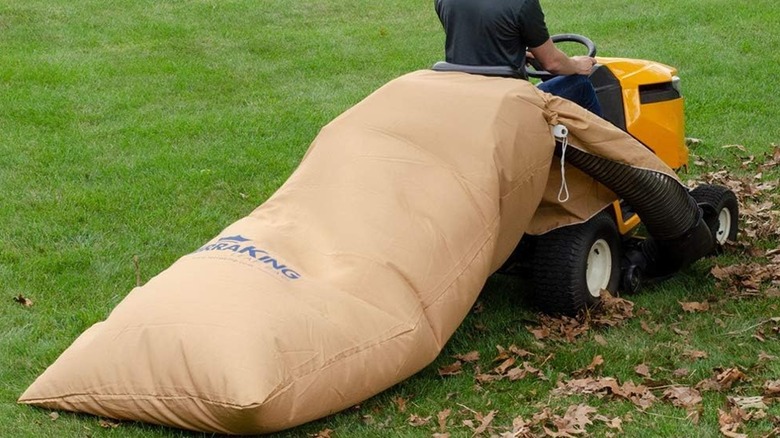 man riding mower with leaf bag