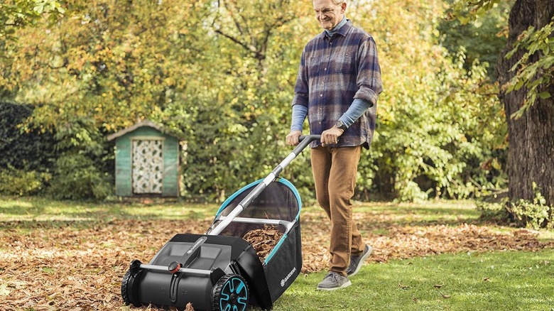 man pushing leaf sweeper