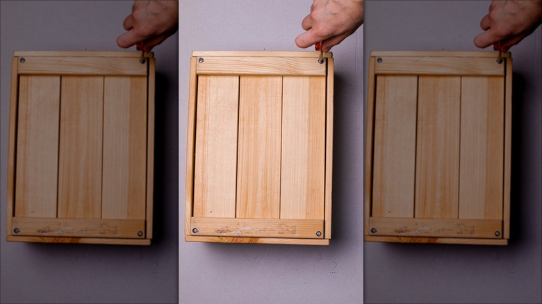 hand screwing a wood box