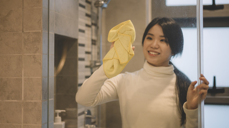 woman cleaning with towel