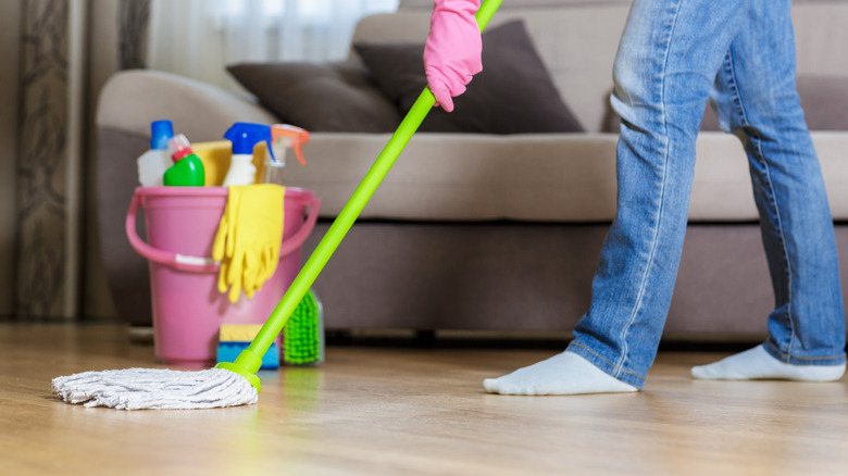 person mopping hardwood floor