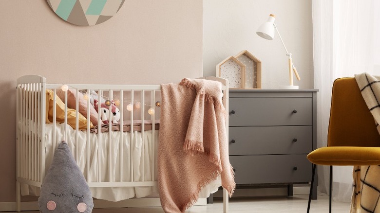 Crib on pink wall accent 