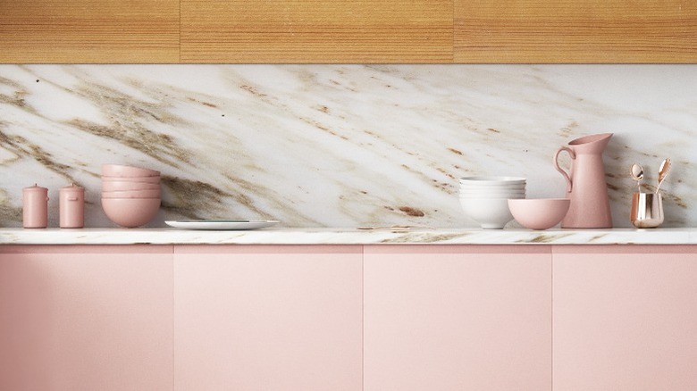 Pink cabinets and marble backsplash