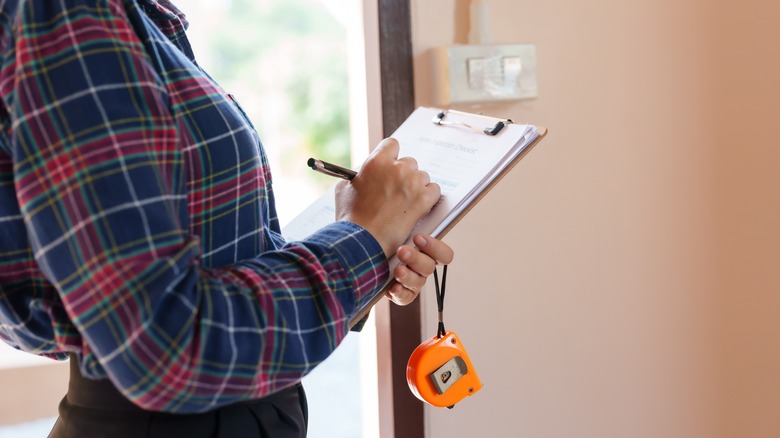 Lady carrying out home inspection