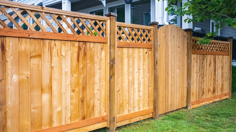 A neat wooden fence with back rails