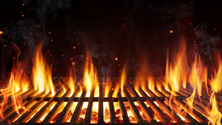 Closeup of flames coming out of charcoal grill