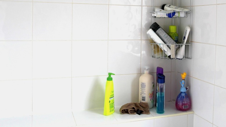 bathroom shower crowded with bottles