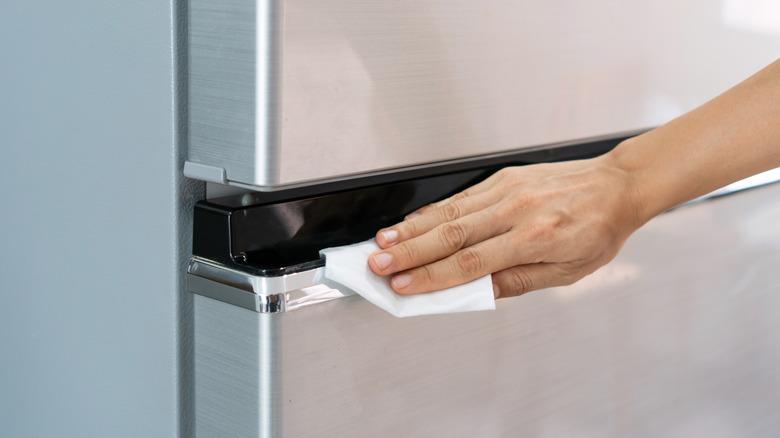 Stainless steel refrigerator being cleaned 